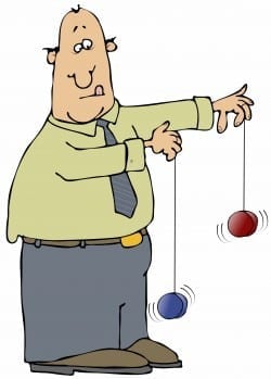 Man attempting to work two yo-yo's