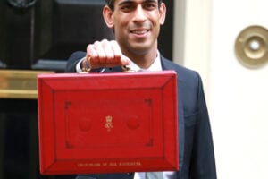 The chancellor holding his red budget case. How will he recoup the cost of Covid 19?